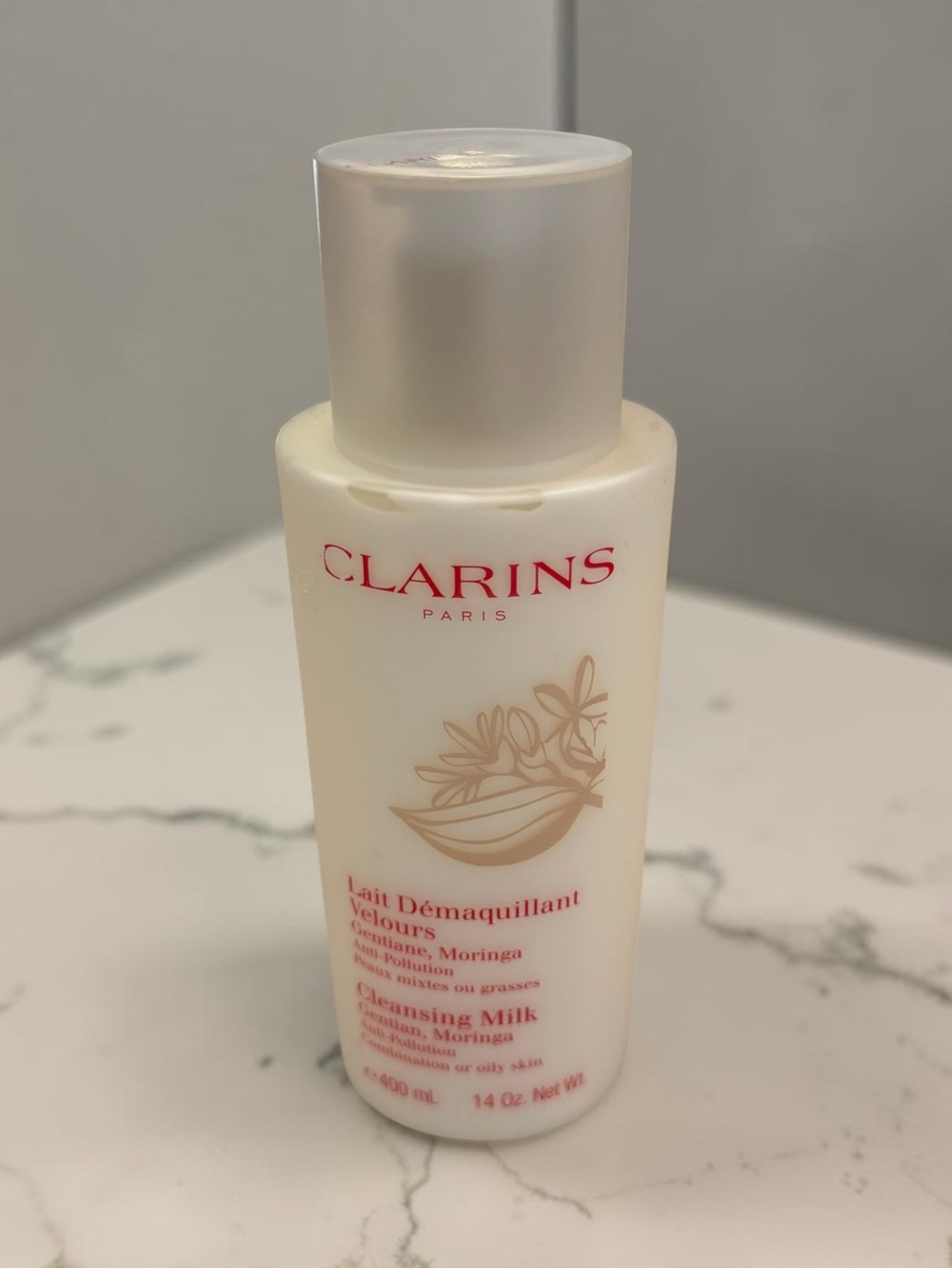 Clarins Cleansing Milk with Red Logo on Cream Bottle